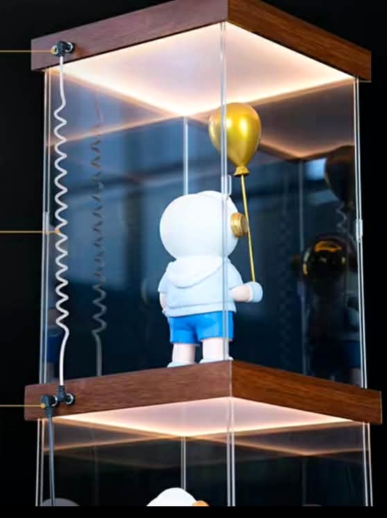 Stacked illuminated display cases connected with a coiled link cable