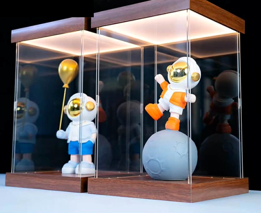 Two illuminated display cases holding astronaut collectibles